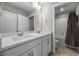 Bright bathroom with double sink vanity and tile-surround tub at 17311 Rose Mallow St, Parker, CO 80134