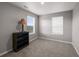 Bedroom with neutral walls, carpet, and a dark bookcase next to the window at 17311 Rose Mallow St, Parker, CO 80134