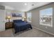 Bright bedroom with natural light from two large windows and blue comforter set at 17311 Rose Mallow St, Parker, CO 80134
