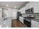 Modern kitchen with stainless steel appliances, quartz countertops, and ample cabinet storage space at 17311 Rose Mallow St, Parker, CO 80134