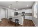 Bright kitchen with an island, sleek countertops, stainless steel appliances and modern white cabinetry at 17311 Rose Mallow St, Parker, CO 80134