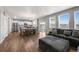 Open-concept space featuring living area, dining table, kitchen, and plenty of natural light at 17311 Rose Mallow St, Parker, CO 80134