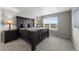 Bedroom with a large window and sizable black bed frame with matching side tables and lamps at 17311 Rose Mallow St, Parker, CO 80134