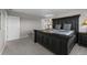 Spacious bedroom featuring a large dark wood bed frame and neutral gray carpeting at 17311 Rose Mallow St, Parker, CO 80134