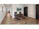 Cozy sitting room with comfortable leather chairs, warm wood floors, and great natural light at 17311 Rose Mallow St, Parker, CO 80134