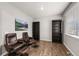 Inviting sitting room featuring leather chairs, decorative shelves, and natural light from a window at 17311 Rose Mallow St, Parker, CO 80134