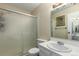 Bright bathroom features a vanity with sink and mirror, and a frosted glass enclosed shower at 3657 S Laredo St # E, Aurora, CO 80013
