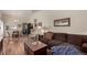 Open-concept living room showcasing hardwood floors, comfortable seating, and a seamless flow to the dining area at 3657 S Laredo St # E, Aurora, CO 80013