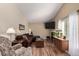 Inviting living room with vaulted ceilings, a cozy fireplace, hardwood floors, and comfortable seating area at 3657 S Laredo St # E, Aurora, CO 80013