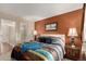 Cozy primary bedroom with unique decor, plush bedding, bright window, and attached bathroom at 3657 S Laredo St # E, Aurora, CO 80013
