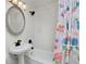 Bathroom with a sink, a shower, and a colorful, patterned shower curtain at 5525 Pierce Ct, Arvada, CO 80002