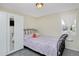 Small bedroom with white walls, a large window, a bed with patterned bedding, and built in wardrobe at 5525 Pierce Ct, Arvada, CO 80002