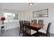 Dining room featuring a table with seating for six, a mirror, and a large window at 5525 Pierce Ct, Arvada, CO 80002