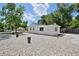 View of the home's side with white paint, landscaping rocks, and a neat, well-maintained yard with beautiful mature trees at 5525 Pierce Ct, Arvada, CO 80002