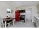 Charming kitchen with a vintage red refrigerator and modern stainless steel appliances at 5525 Pierce Ct, Arvada, CO 80002