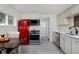 Well-lit kitchen with a vintage red refrigerator, stainless steel appliances, and stylish cabinetry at 5525 Pierce Ct, Arvada, CO 80002