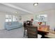Bright living room with a large window, neutral carpet, and a comfortable blue sofa at 5525 Pierce Ct, Arvada, CO 80002