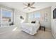 Bright bedroom featuring a ceiling fan, neutral walls and carpet, and a large window providing natural light at 15993 E 112 Pl, Commerce City, CO 80022