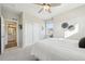 Cozy bedroom with white bedding and a doorway to the bathroom, offering a peaceful retreat at 15993 E 112 Pl, Commerce City, CO 80022