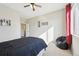 Well lit bedroom with a ceiling fan, neutral walls and carpet, and a bright window at 15993 E 112 Pl, Commerce City, CO 80022