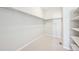 A walk-in closet with a minimalist design, open shelving, and ample storage space at 15993 E 112 Pl, Commerce City, CO 80022