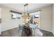 Dining area featuring a modern table, chairs, and natural light from the sliding glass door at 15993 E 112 Pl, Commerce City, CO 80022