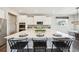 Kitchen with a large island, seating, and white cabinets at 15993 E 112 Pl, Commerce City, CO 80022