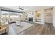Bright living room featuring a fireplace, large windows, and hardwood floors at 15993 E 112 Pl, Commerce City, CO 80022