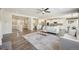 Spacious living room with hardwood floors, neutral decor, and seamless flow to the kitchen at 15993 E 112 Pl, Commerce City, CO 80022