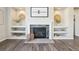 Cozy living room with a stone fireplace, built-in shelves, and neutral decor with modern flooring at 15993 E 112 Pl, Commerce City, CO 80022