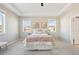 Comfortable main bedroom featuring neutral decor, tray ceilings, and three windows with neighborhood views at 15993 E 112 Pl, Commerce City, CO 80022
