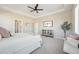Spacious bedroom with a tray ceiling, large windows, and neutral decor at 15993 E 112 Pl, Commerce City, CO 80022