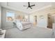 Spacious main bedroom with a ceiling fan and a view of the adjoining bathroom and walk-in closet at 15993 E 112 Pl, Commerce City, CO 80022