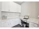 Bright office with stylish gray walls, white cabinets and countertops, and dark wood-look floors at 15993 E 112 Pl, Commerce City, CO 80022