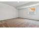 Unfurnished basement bedroom with neutral carpet, white walls, and a window providing natural light at 24778 E 40Th Ave, Aurora, CO 80019