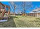 Expansive backyard with lush lawn, mature trees, and wood fence at 11437 W 103Rd Ave, Broomfield, CO 80021
