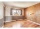 Comfortable bedroom with a paneled accent wall, wood flooring, and a checkered wallpaper design at 11437 W 103Rd Ave, Broomfield, CO 80021