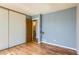 Standard bedroom featuring hardwood floors, a big window, and an extra-wide closet with sliding doors at 11437 W 103Rd Ave, Broomfield, CO 80021