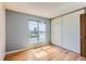 Cozy bedroom features hardwood floors, a big window, and an extra-wide closet with sliding doors at 11437 W 103Rd Ave, Broomfield, CO 80021
