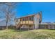 Home exterior features a screened-in deck, a well-maintained yard, and mature trees at 11437 W 103Rd Ave, Broomfield, CO 80021