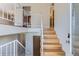 Open staircase with hardwood steps and white railings that lead to the second floor landing at 11437 W 103Rd Ave, Broomfield, CO 80021