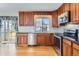 Bright kitchen area featuring wood cabinets, stainless steel appliances, and a door to the back porch at 11437 W 103Rd Ave, Broomfield, CO 80021