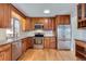 Well-lit kitchen features stainless steel appliances, granite countertops, and beautiful wood cabinets at 11437 W 103Rd Ave, Broomfield, CO 80021