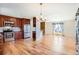 Open kitchen with stainless steel appliances, dark cabinets, and hardwood floors open to the living area at 11437 W 103Rd Ave, Broomfield, CO 80021