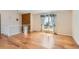 Bright living room with hardwood floors, large window with drapes, and adjacent to the dining area at 11437 W 103Rd Ave, Broomfield, CO 80021