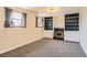Spacious living room area with a fireplace, built-in shelving, and two windows at 11437 W 103Rd Ave, Broomfield, CO 80021