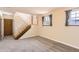 Cozy room featuring a wooden staircase with carpet, hardwood floors, and two windows at 11437 W 103Rd Ave, Broomfield, CO 80021