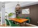 Elegant dining room with rich wood table, green velvet chairs, and stylish lighting at 1885 S Quebec Way # J106, Denver, CO 80231