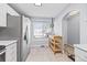 Bright, modern kitchen featuring a movable wood island, stainless steel refrigerator, and a window at 1885 S Quebec Way # J106, Denver, CO 80231