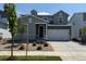 Two-story home featuring a two car garage, tasteful landscaping and a modern exterior paint scheme at 1432 Orchard St, Brighton, CO 80601